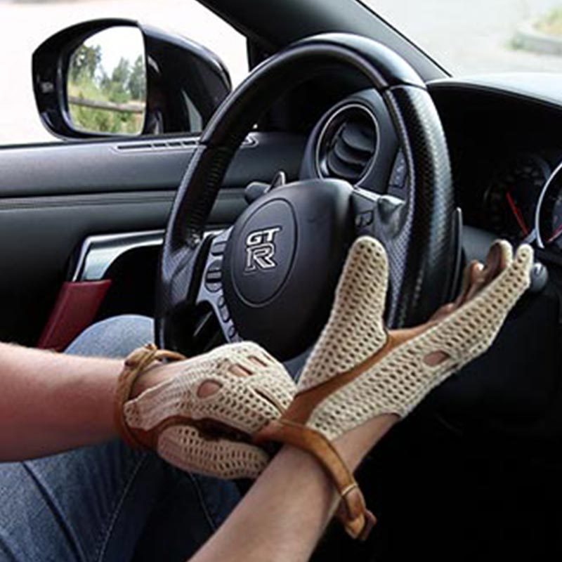 Driving gloves on a Nissan GTR steering wheel
